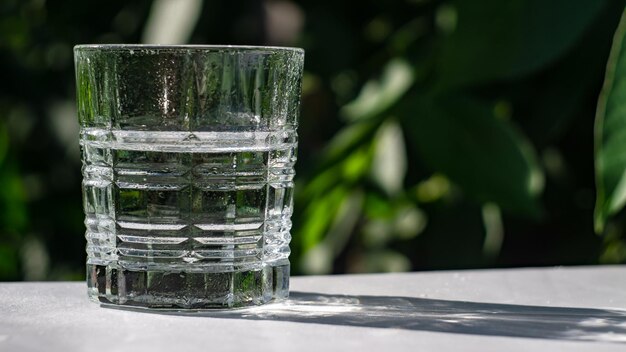 glass of water on the table in the garden