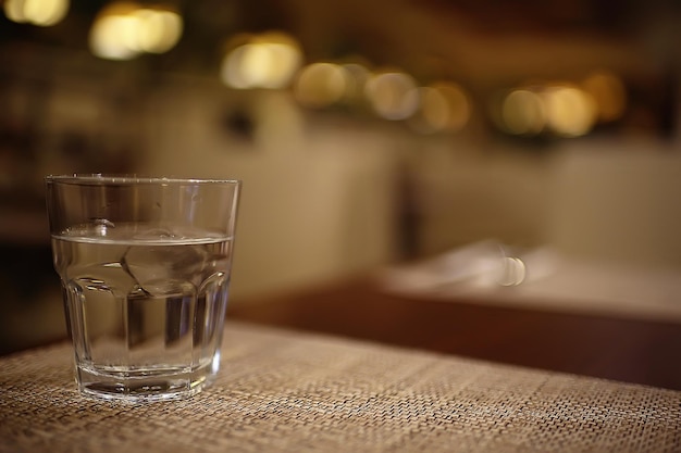 glass of water with ice in the restaurant / cold clear clear water in a glass with ice pieces