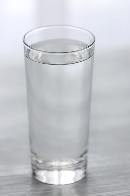 Glass of water on wooden table