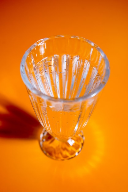 Glass of water on the yellow table