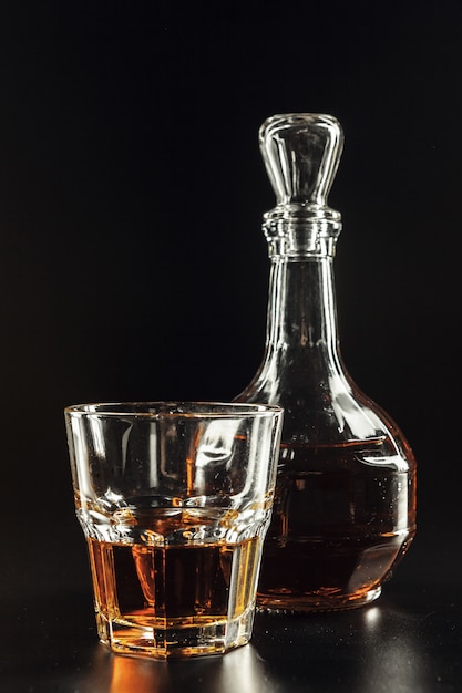 Glass of the whiskey and a square decanter