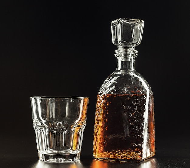 Glass of the whiskey and a square decanter