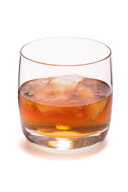 Glass of whiskey with ice isolated