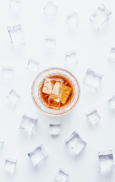 Glass of whiskey with ice on a white background with place for text