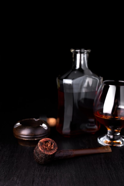 glass of whiskey with smoking cigar. whisky, tobacco.