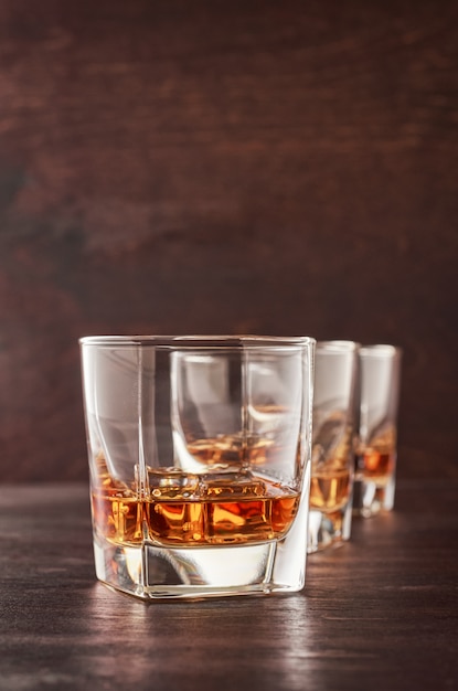 Glass of whiskey on a wooden table