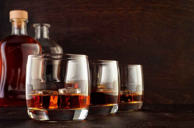 Glass of whiskey on a wooden table