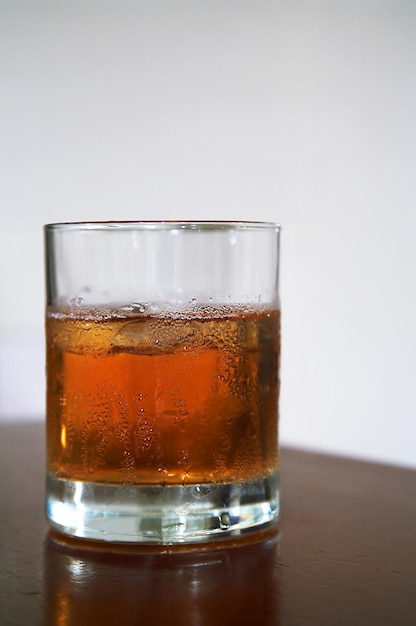 Glass of whisky with an ice