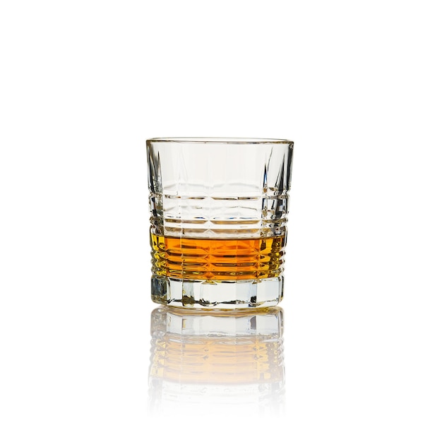 Glass of whisky without ice and reflection studio shot