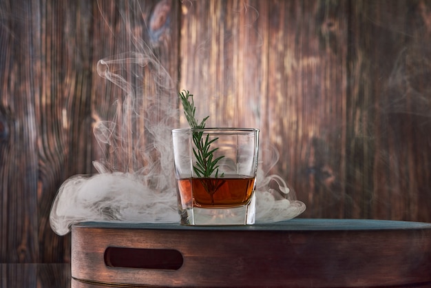 Glass of whisky on the wooden table