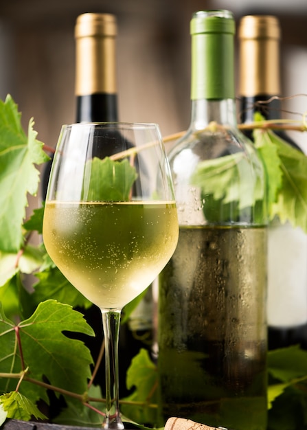 Glass of white wine on a barrel on white background