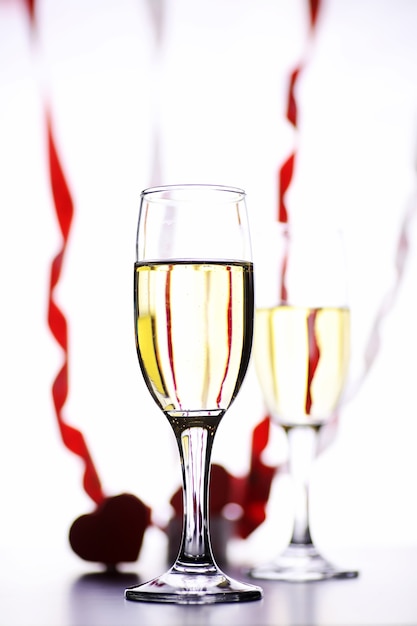 glass of white wine on a table on a white background isolate