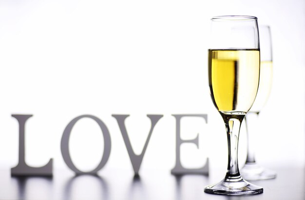 Glass of white wine on a table on a white background isolate