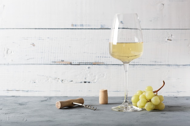 Glass of white wine on vintage wooden table