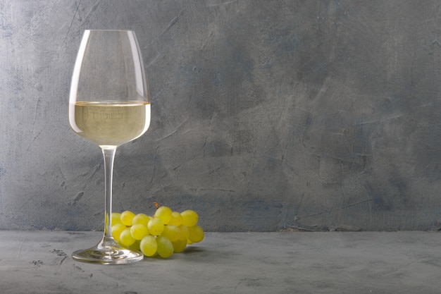 Glass of white wine on vintage wooden table