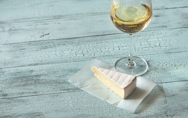 Glass of white wine with Brie