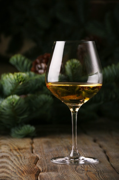 Glass of white wine with Christmas spruce