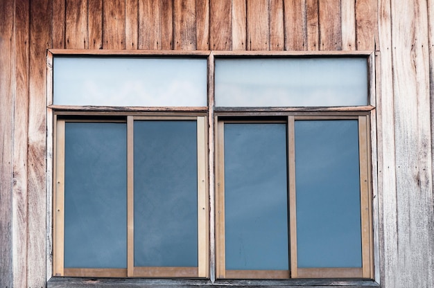 Glass window on old wooden wall background