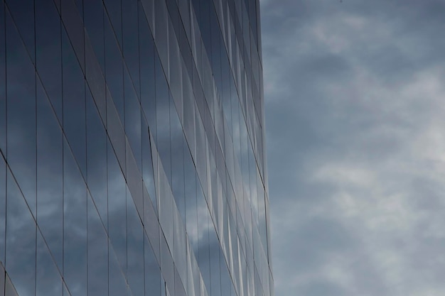 Glass windows of a building and its blue sky reflection