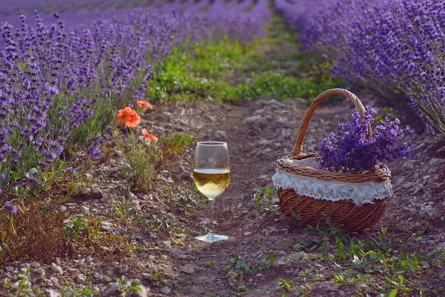 Glass of wine and basket in the lavender field