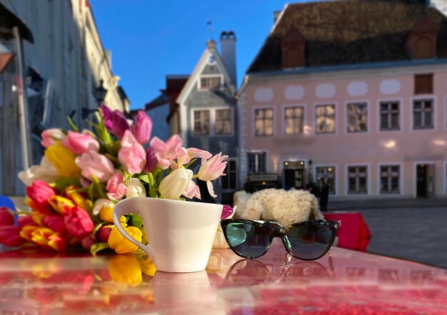 Glass of wine and cup coffe in street cafe table in tallinn old town