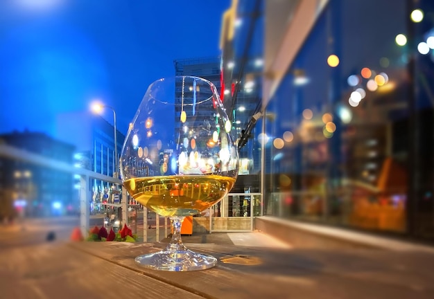 Glass of wine and cup of coffee and candle on street cafe table
in medieval city tallinn old town