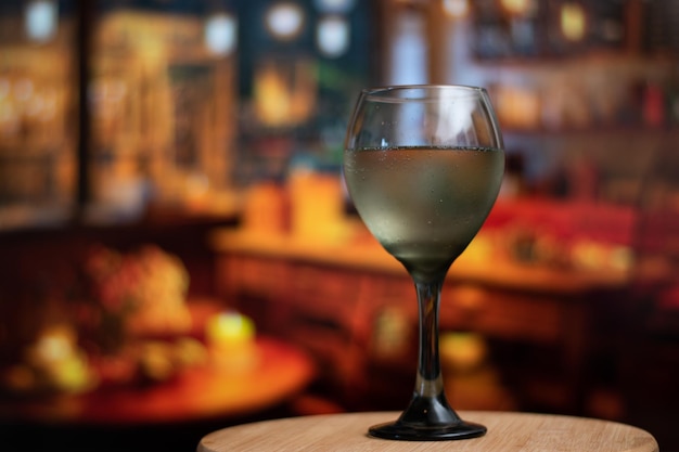 A glass of wine over a table in a bar vintage