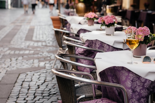 A glass of wine on the table of a beautiful coffee shop in the center of Europe. Rest