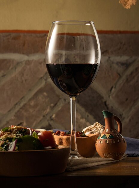 Glass of wine on a table with dishes