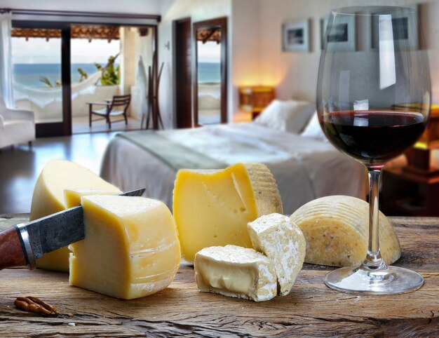 Glass of wine with cheese at the beach hotel room