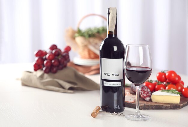 Glass of wine with food on blurred background