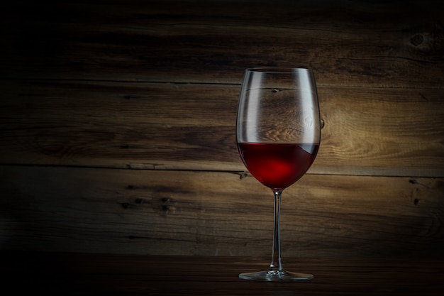 Glass of wine on a wooden background