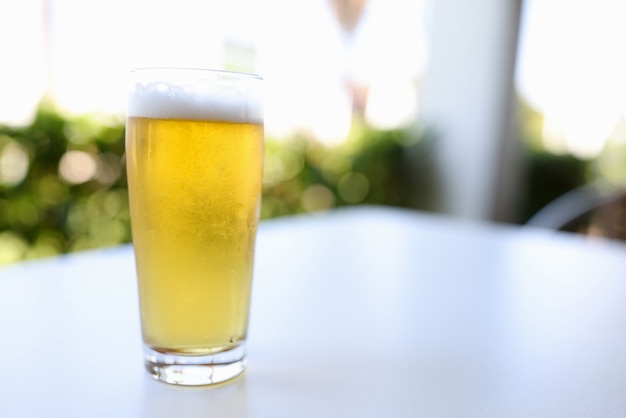 Glass with beer on table