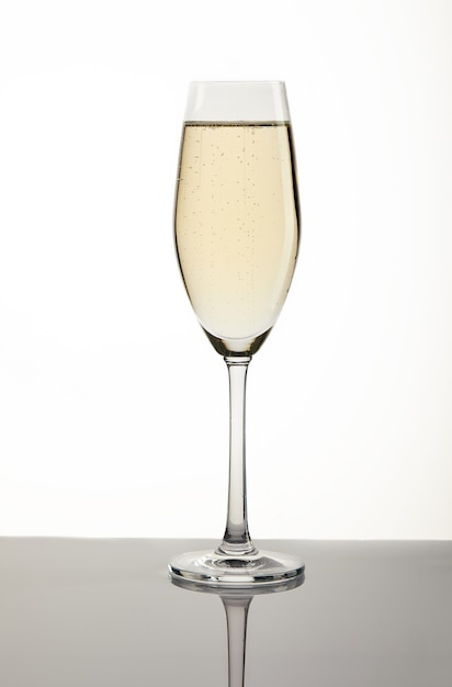 Glass with champagne on white