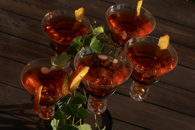 glass with cold summer drink and fruits cocktail