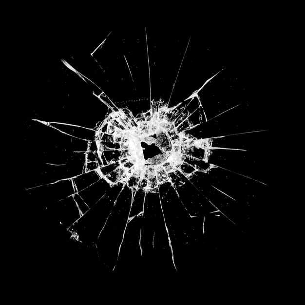 Premium Photo | Glass with a hole and cracks isolated on a black background