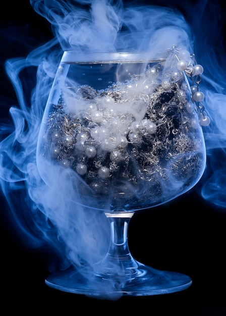 Glass with jewelry in smoke