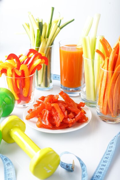 glass with juice cut vegetables into strips diet food snacks on a plate dried pieces of carpacci