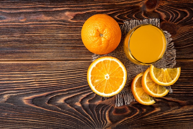 glass with orange juice on table