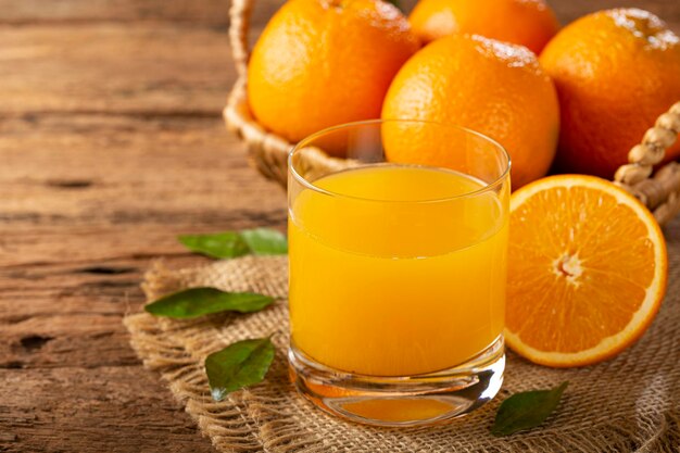 Glass with orange juice on the table.