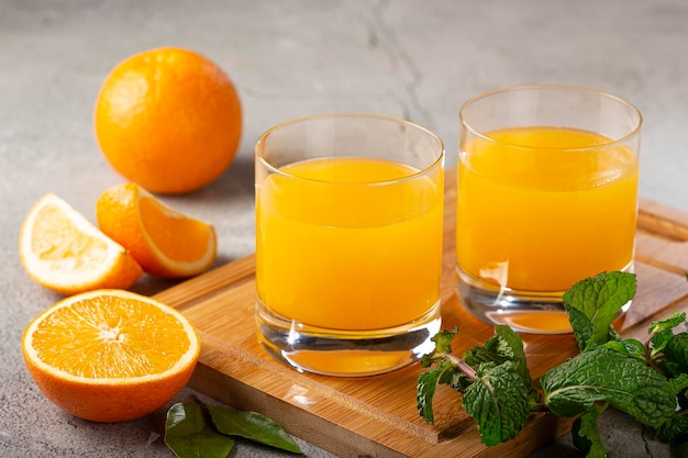 Glass with orange juice on the table.