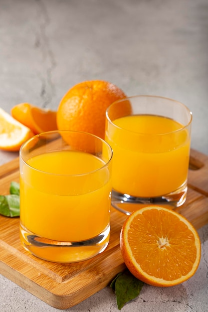 Glass with orange juice on the table.