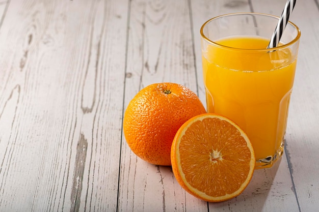 Glass with orange juice on the table.