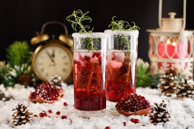 Glass with pomegranate Margarita with candied cranberries, rosemary. Perfect cocktail for a Christmas party