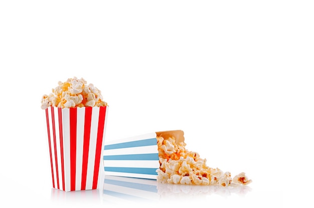 Glass with popcorn on a white background