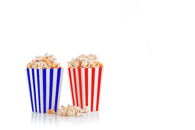 Glass with popcorn on a white background