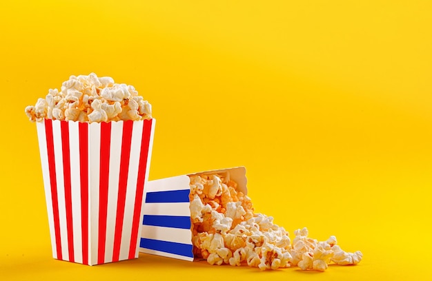 Photo glass with popcorn on a yellow background