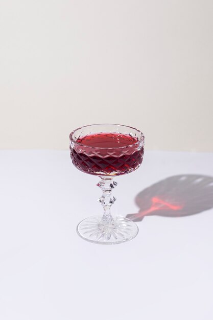 Glass with red wine on the table on a light background. Top view, flat lay