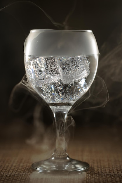 Glass with soda and ice with smoke effect