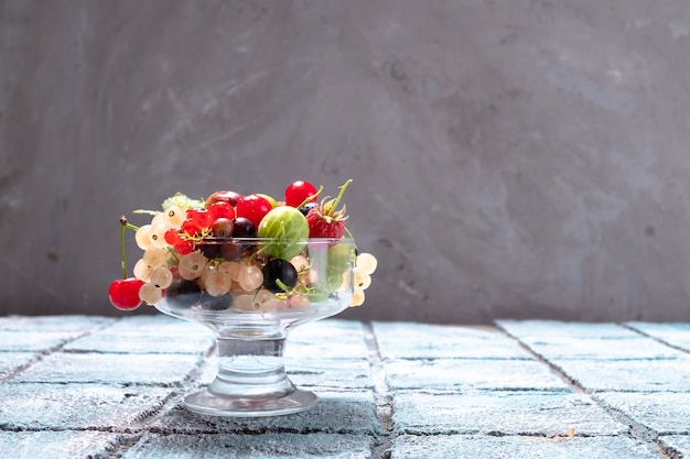 A glass with various garden berries